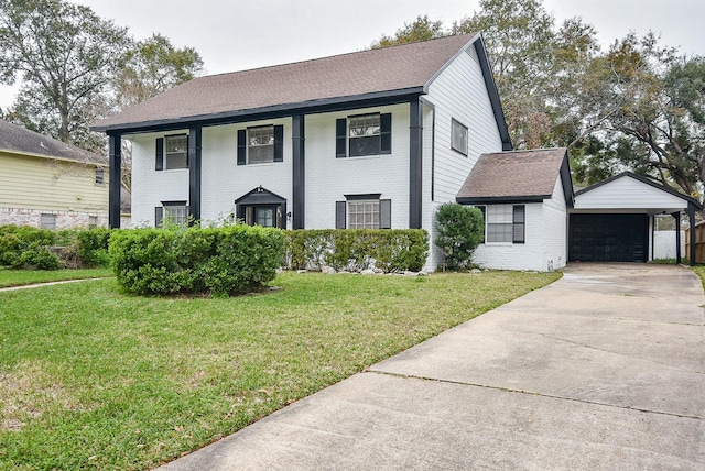 colonial house featuring a front lawn and a garage