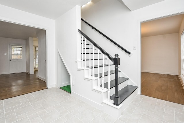 staircase featuring wood-type flooring