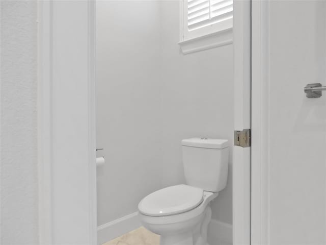 bathroom featuring tile patterned flooring and toilet