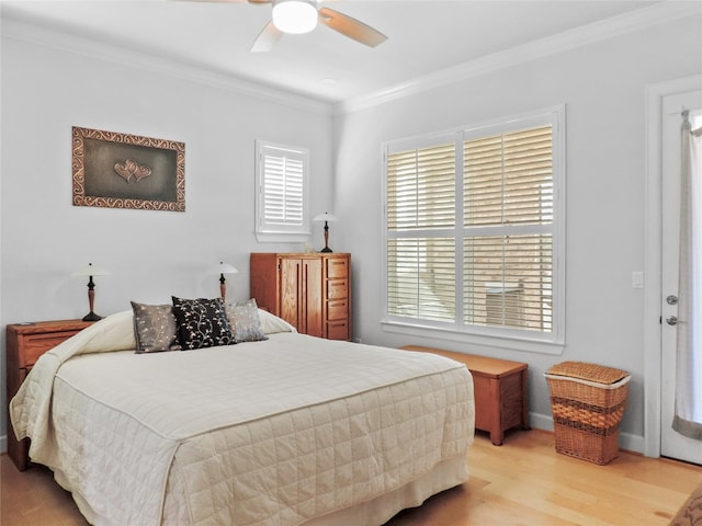 bedroom with light hardwood / wood-style flooring, ceiling fan, and ornamental molding