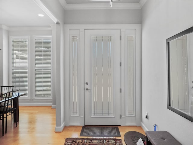 entrance foyer featuring light hardwood / wood-style floors and ornamental molding