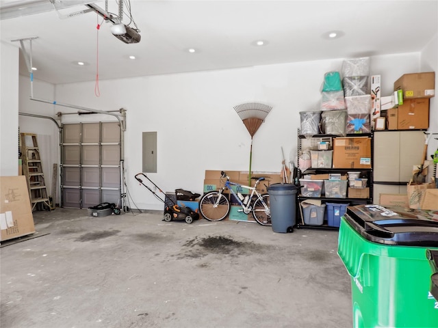 garage featuring electric panel and a garage door opener