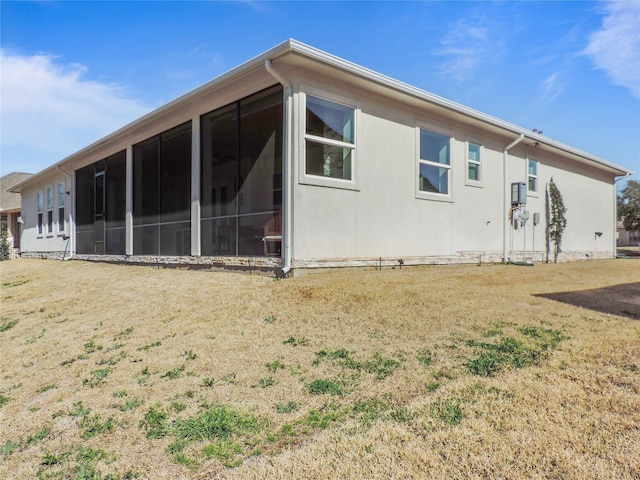 rear view of property featuring a sunroom