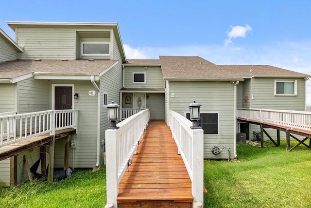 rear view of property featuring a yard