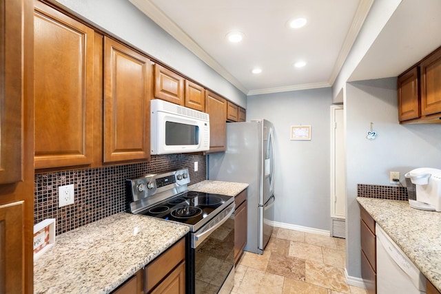 kitchen with light stone countertops, decorative backsplash, stainless steel appliances, and crown molding