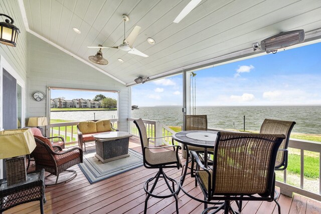 deck featuring ceiling fan, a water view, and an outdoor hangout area