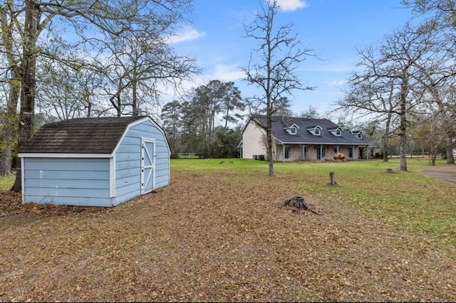 exterior space with a front lawn and a storage unit