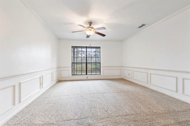 carpeted empty room featuring crown molding and ceiling fan