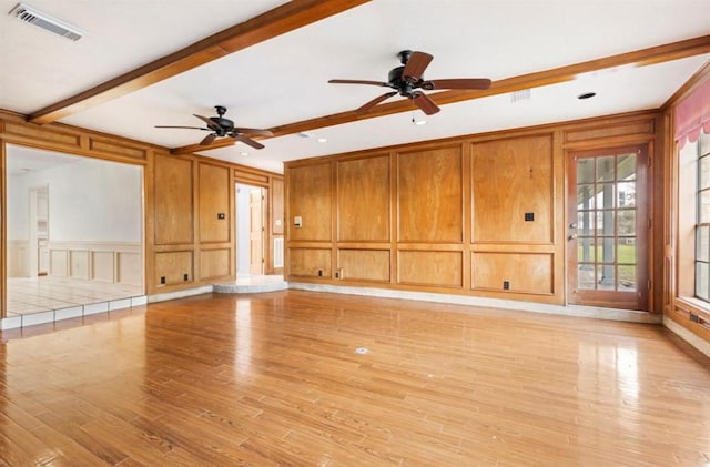 unfurnished living room with ceiling fan, beam ceiling, and light hardwood / wood-style floors