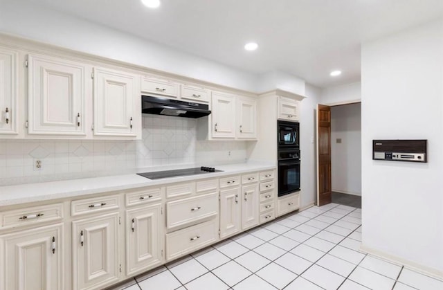 kitchen featuring black appliances, light tile patterned flooring, and backsplash