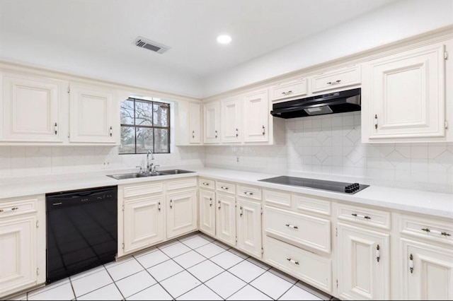 kitchen with decorative backsplash, light tile patterned floors, sink, and black appliances