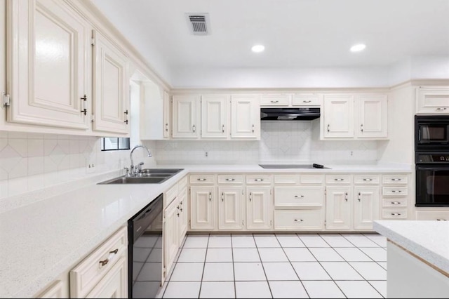 kitchen with black appliances, decorative backsplash, light tile patterned flooring, and sink