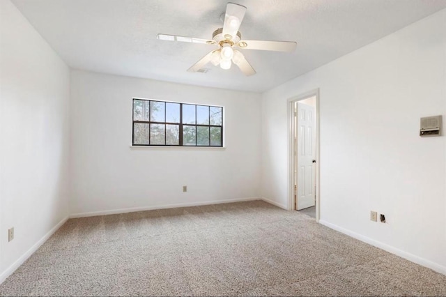 unfurnished room with ceiling fan and carpet