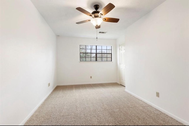 carpeted empty room featuring ceiling fan