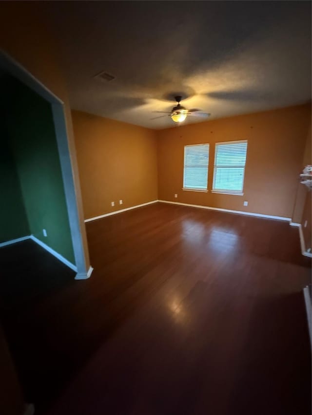 spare room featuring ceiling fan and hardwood / wood-style floors