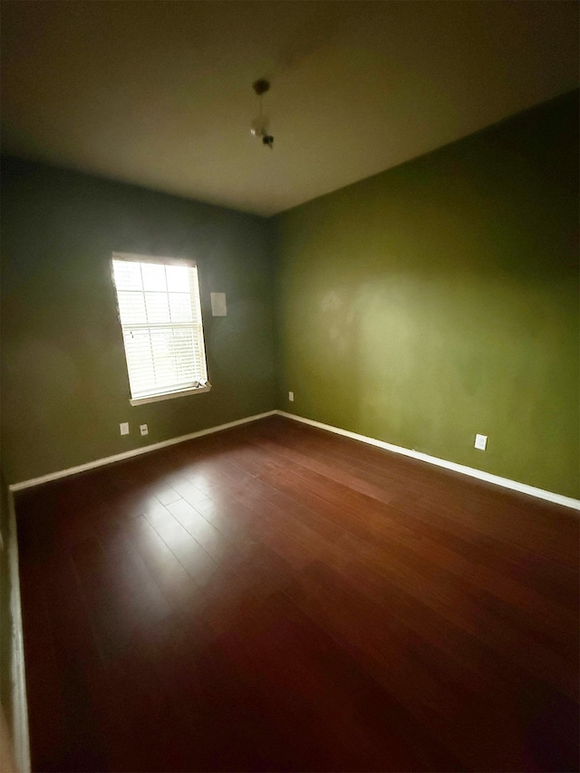 unfurnished room with wood-type flooring