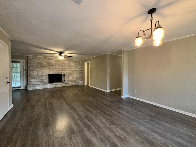 unfurnished living room featuring a brick fireplace, baseboards, dark wood-style floors, and ceiling fan with notable chandelier