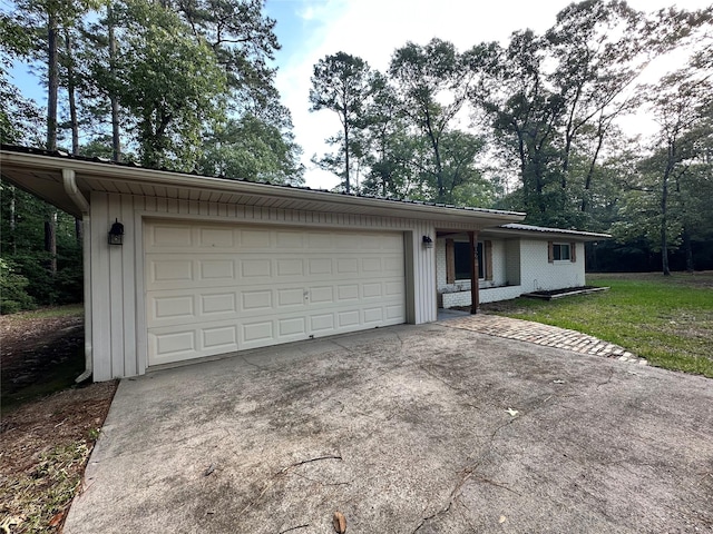 ranch-style house featuring an attached garage and concrete driveway