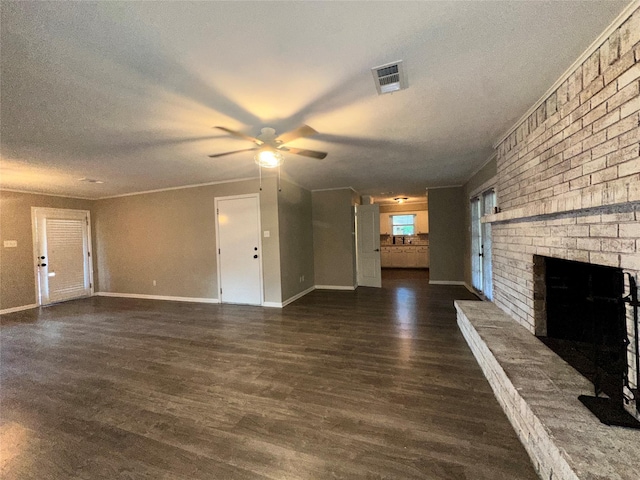 unfurnished living room featuring a fireplace, a ceiling fan, dark wood-type flooring, and visible vents