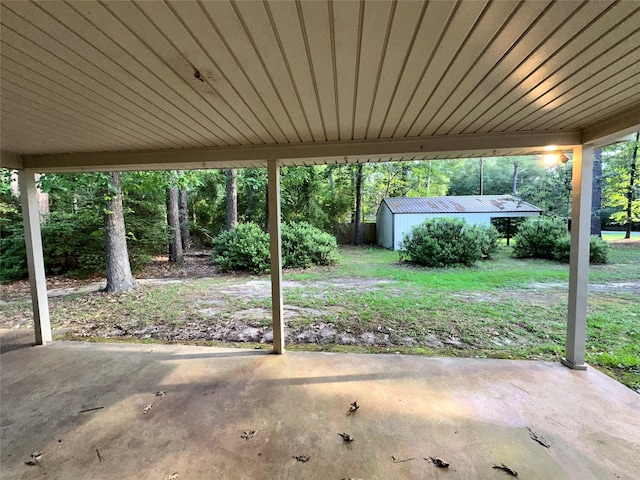 view of patio / terrace with an outbuilding and a storage shed