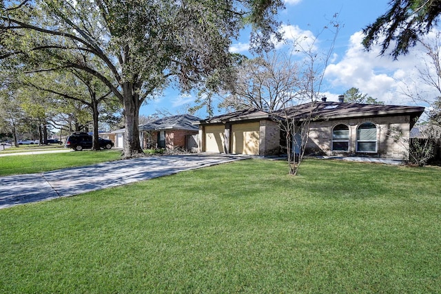 single story home featuring a front yard and a garage