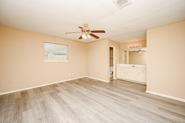 spare room with light hardwood / wood-style floors and sink