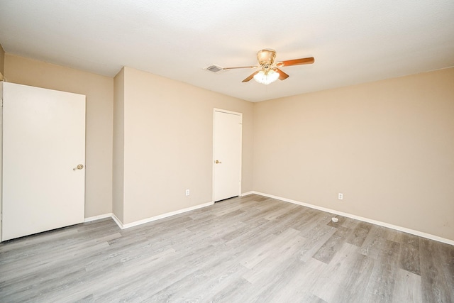 spare room featuring light hardwood / wood-style floors and ceiling fan