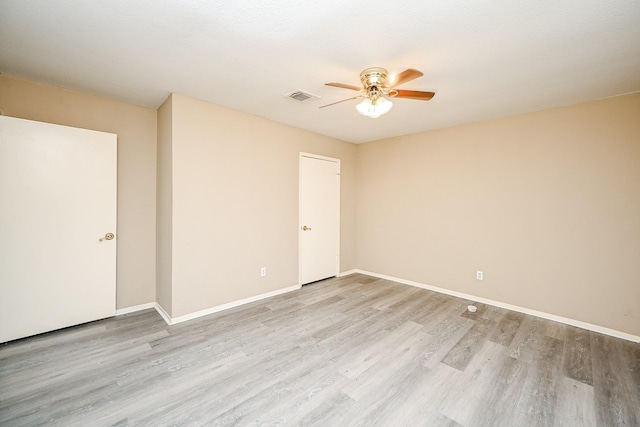 empty room featuring ceiling fan and light hardwood / wood-style flooring