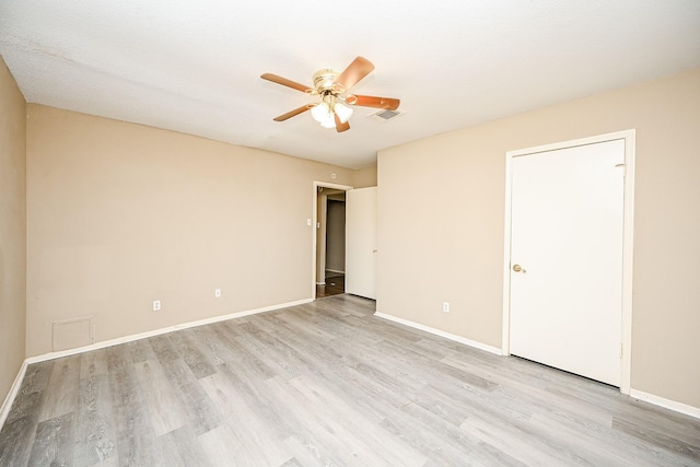 empty room featuring ceiling fan and light hardwood / wood-style floors