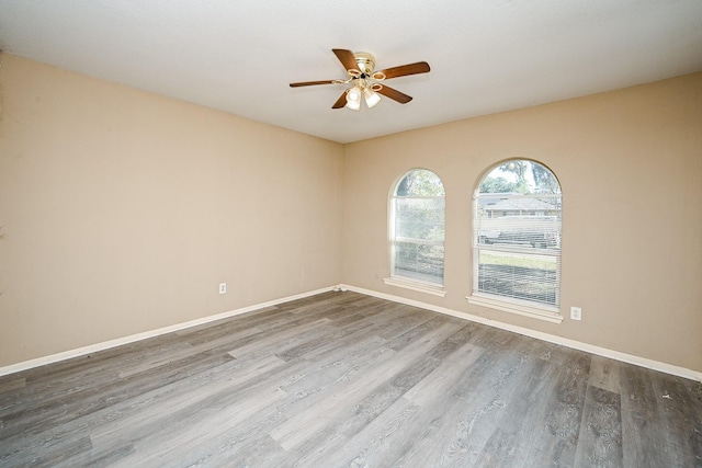 unfurnished room featuring ceiling fan and wood-type flooring