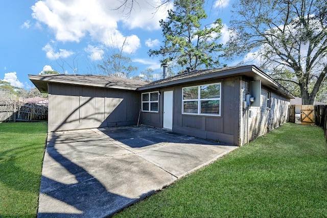 back of property featuring a patio and a lawn