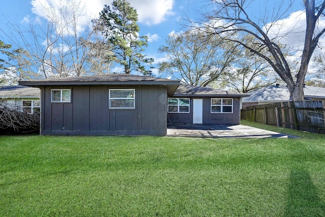 back of house featuring a lawn and a patio area