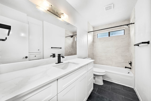 full bathroom with vanity, toilet, and tiled shower / bath