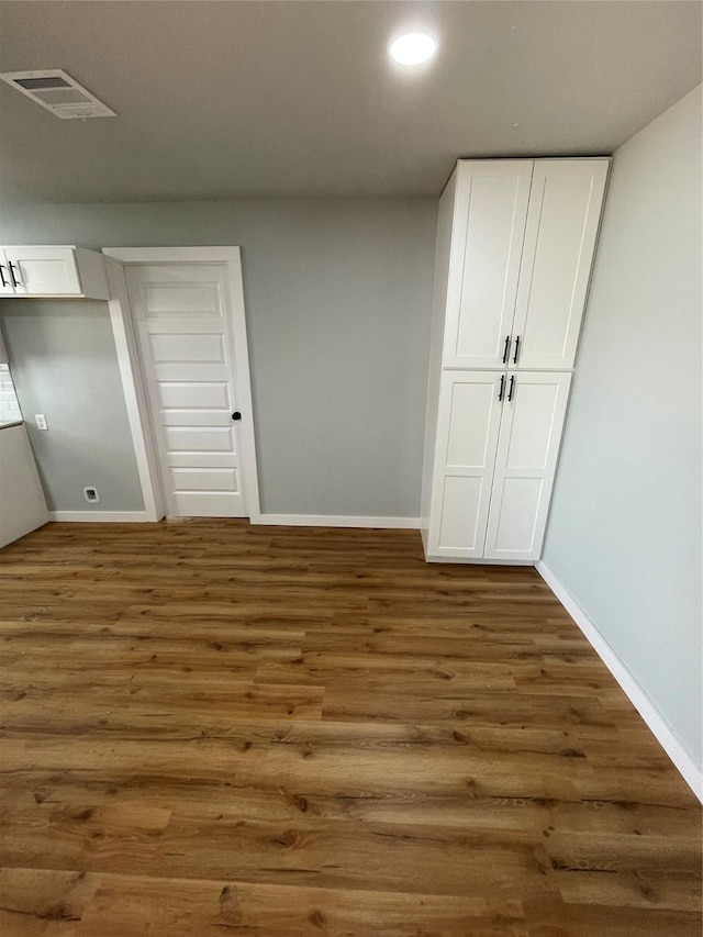 unfurnished bedroom featuring dark hardwood / wood-style floors