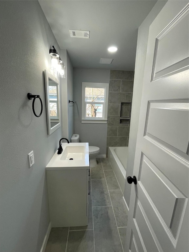 bathroom featuring toilet, vanity, and tile patterned floors