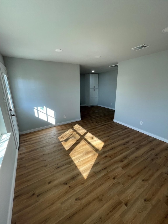 empty room featuring dark wood-type flooring