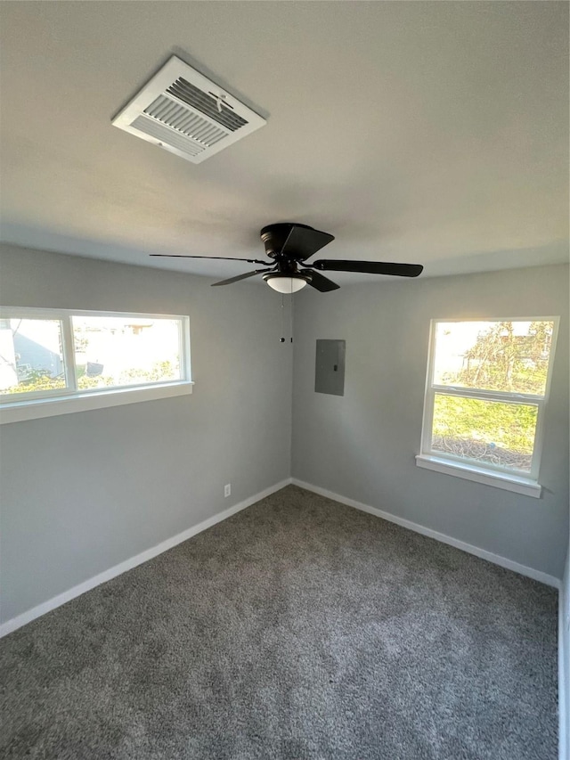 spare room with ceiling fan, carpet flooring, and electric panel