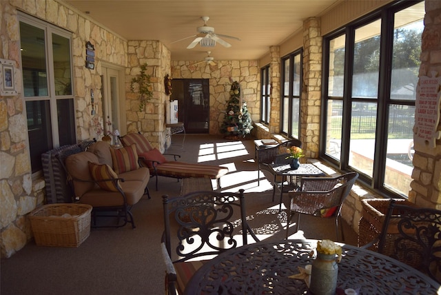 sunroom / solarium with ceiling fan and a healthy amount of sunlight