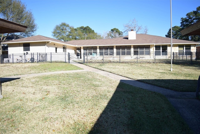 rear view of house with a yard