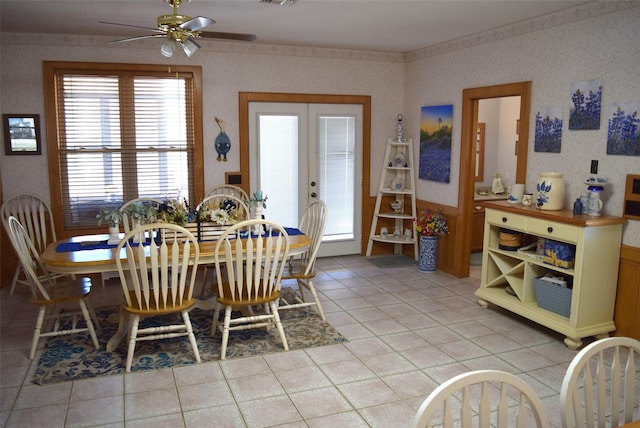 tiled dining area with ceiling fan and french doors