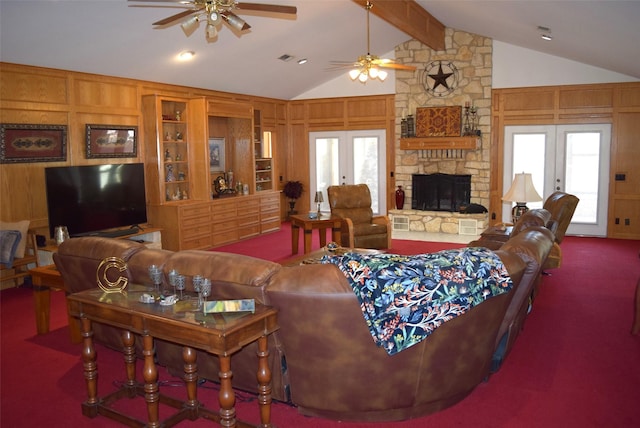 living room with french doors, dark carpet, wooden walls, lofted ceiling with beams, and a fireplace