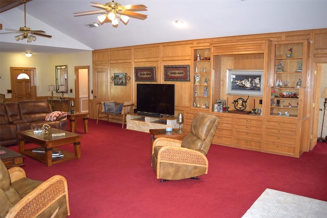 living room with carpet, vaulted ceiling, ceiling fan, and wooden walls