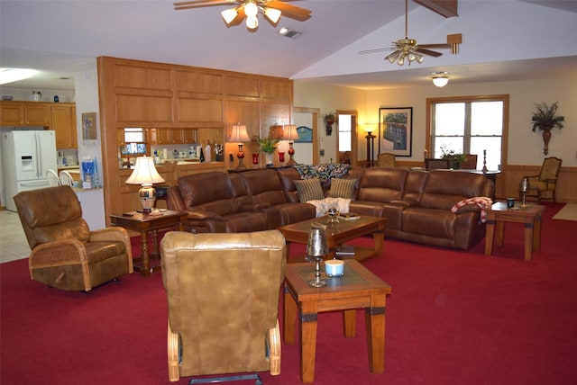 carpeted living room with wood walls, ceiling fan, and lofted ceiling with beams