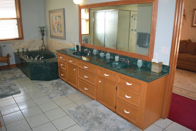 bathroom with tile patterned floors, separate shower and tub, and vanity