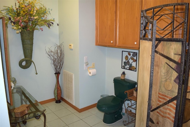 bathroom featuring tile patterned flooring and toilet