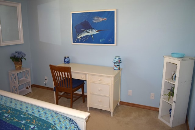 office space featuring built in desk and light colored carpet