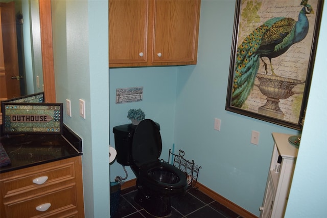 interior space featuring tile patterned floors, vanity, and toilet