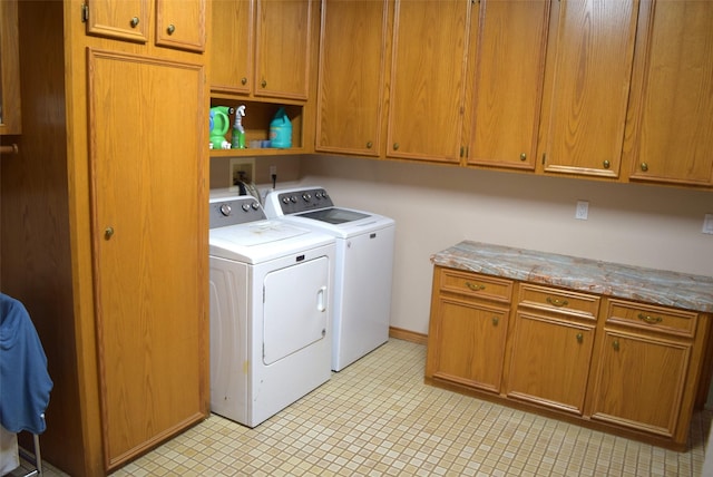 washroom with cabinets and washer and clothes dryer