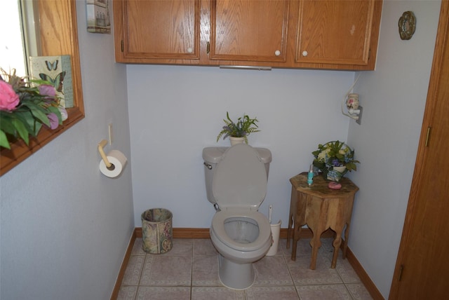 bathroom with toilet and tile patterned floors