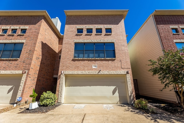 view of front of house with a garage and central air condition unit